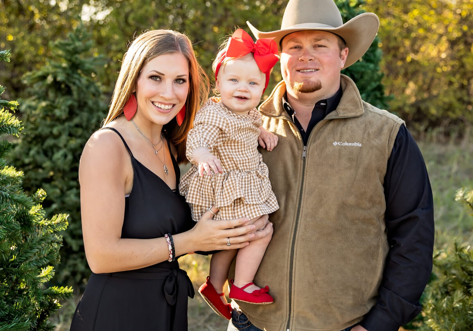 A man and woman holding a little girl.